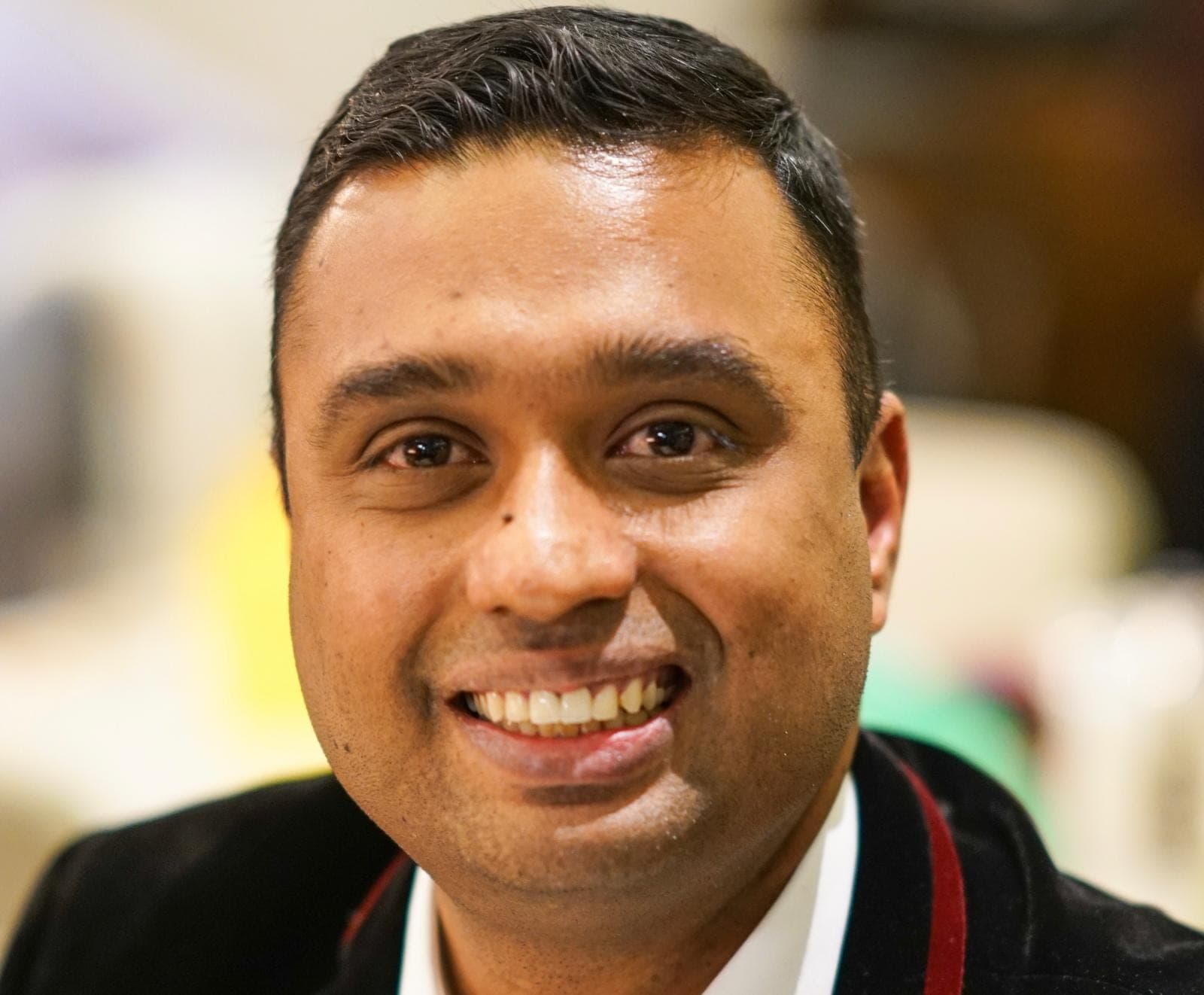 Srini Vankeepuram, smiling, in a dark jacket